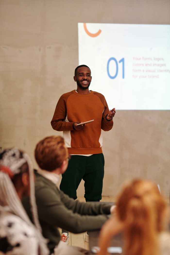 Mastering the First Impression: Your intriguing post title goes here Engaging business presentation in a contemporary indoor setting with diverse audience.