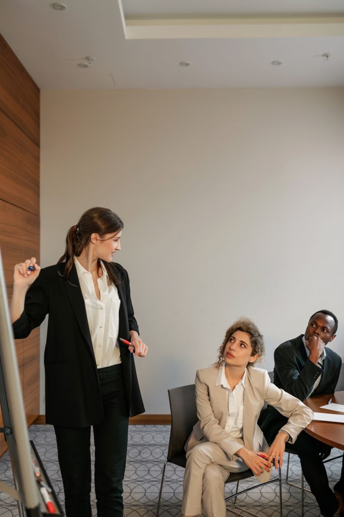 about-hero Group of diverse professionals engaging in a collaborative office meeting indoors.